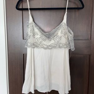 flowy white tank top with floral designed lace